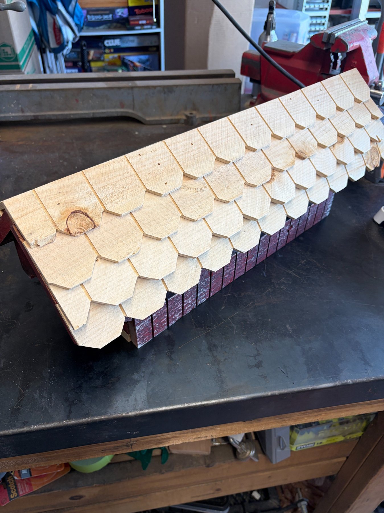 Hand-cut wood shingles on a covered bridge bird feeder